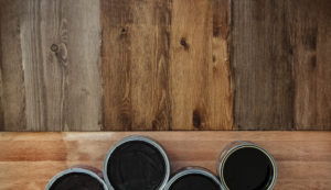 Top view on a newly opened can of wax, varnish, oil, paint on a freshly painted wooden surface. 