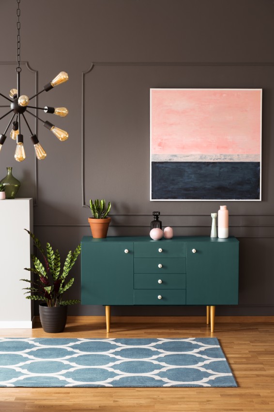 dark greige wall with green sideboard